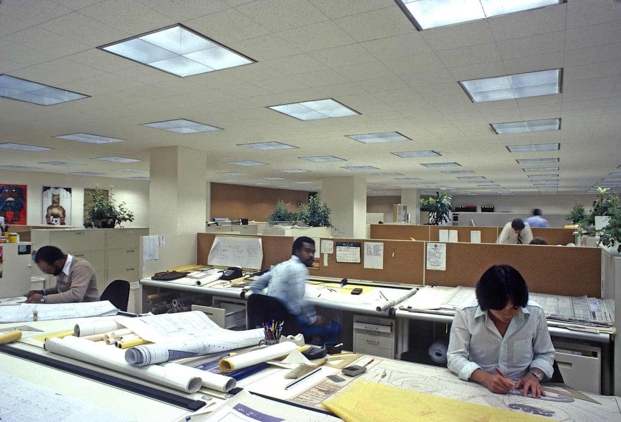 Büro der 1970er Jahre mit horizontaler Beleuchtung für manuelle Aufgaben und Aktenablage.