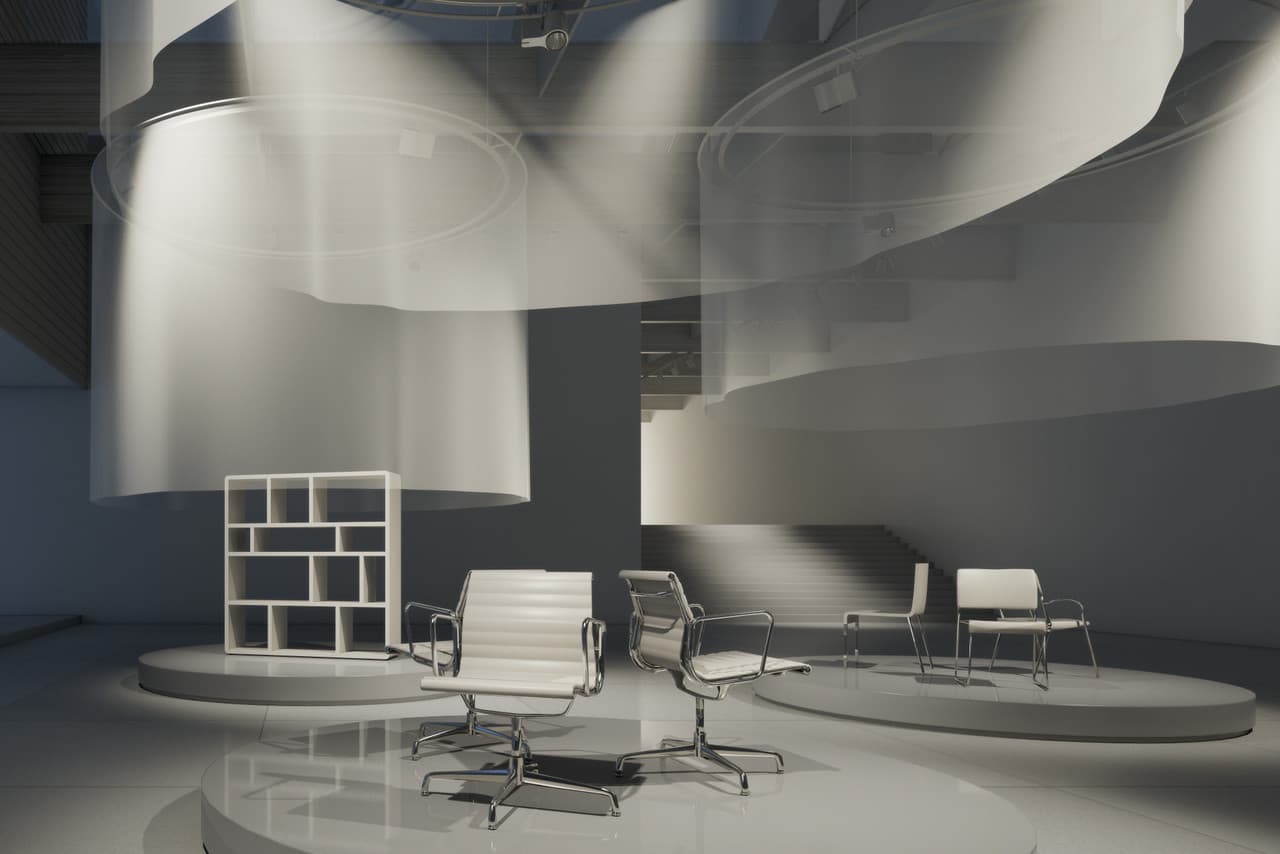 Büroausstellung mit Eames-Stühlen, beleuchtet durch ERCO Lichtlösungen für Akzentuierung und Raumwirkung.
