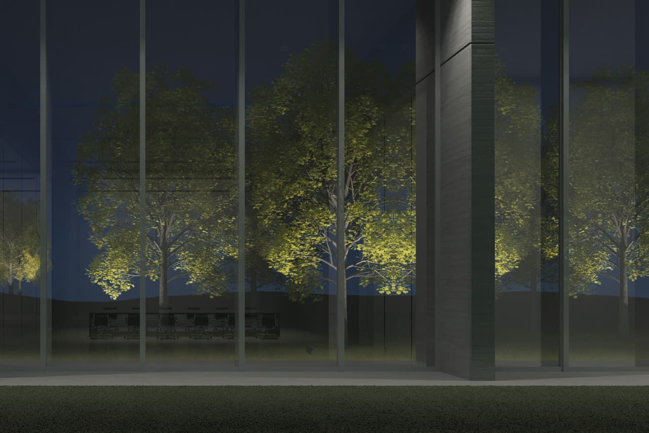 Beleuchtete Bäume durch Fensterfront eines Konferenzraums, Spiegelungen und Lichtdesign im Fokus.