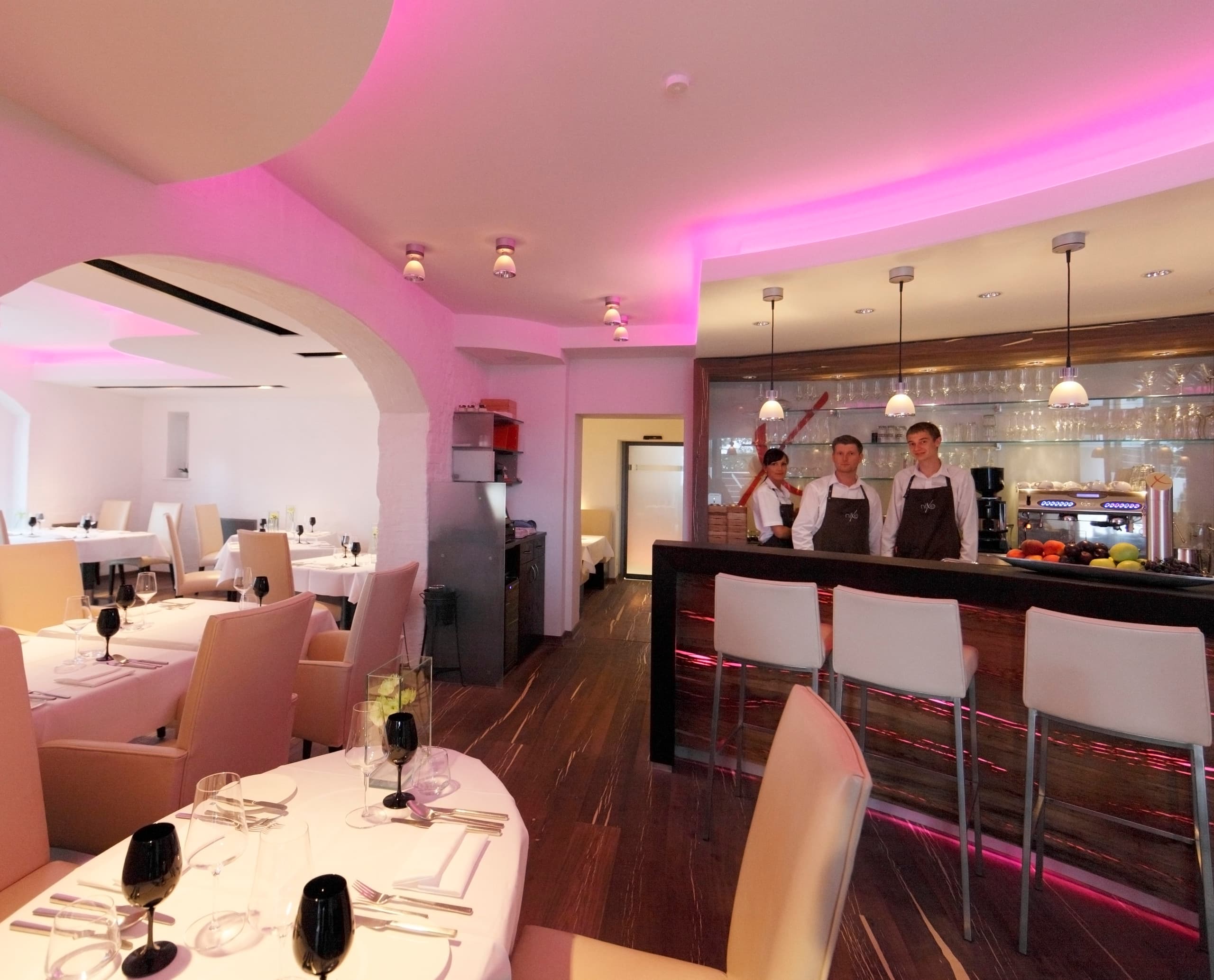 Innenansicht des Hotel Nixe Restaurants mit ERCO Beleuchtung und Personal hinter der Bar.