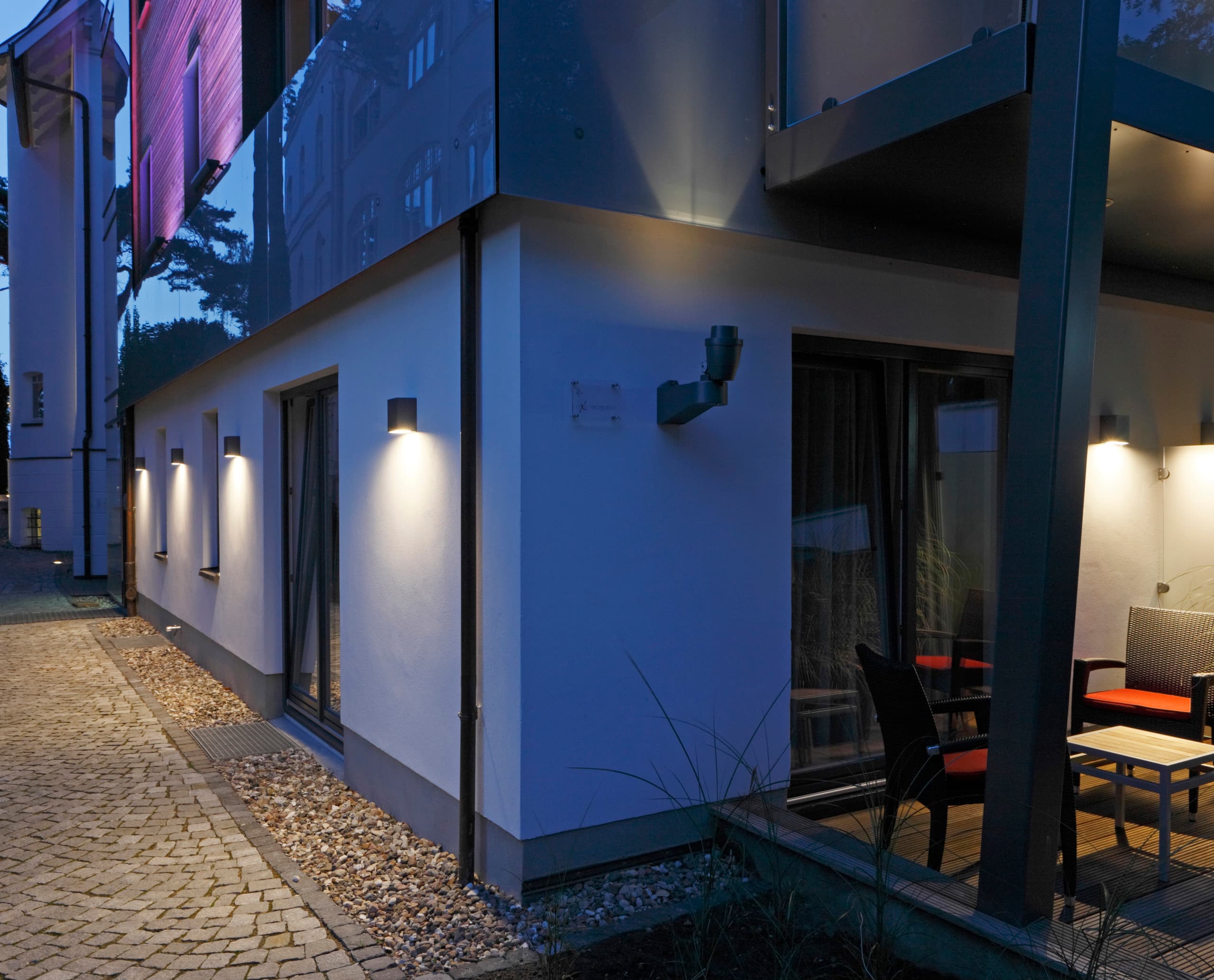 Hotel Nixe Fassade mit ERCO Kubus Wandleuchten und Beamer Projektoren für stimmungsvolle Beleuchtung.