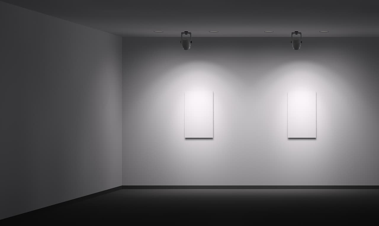 Ausstellungsraum mit ERCO Strahlern, die Kontraste auf weißen Leinwänden erzeugen.