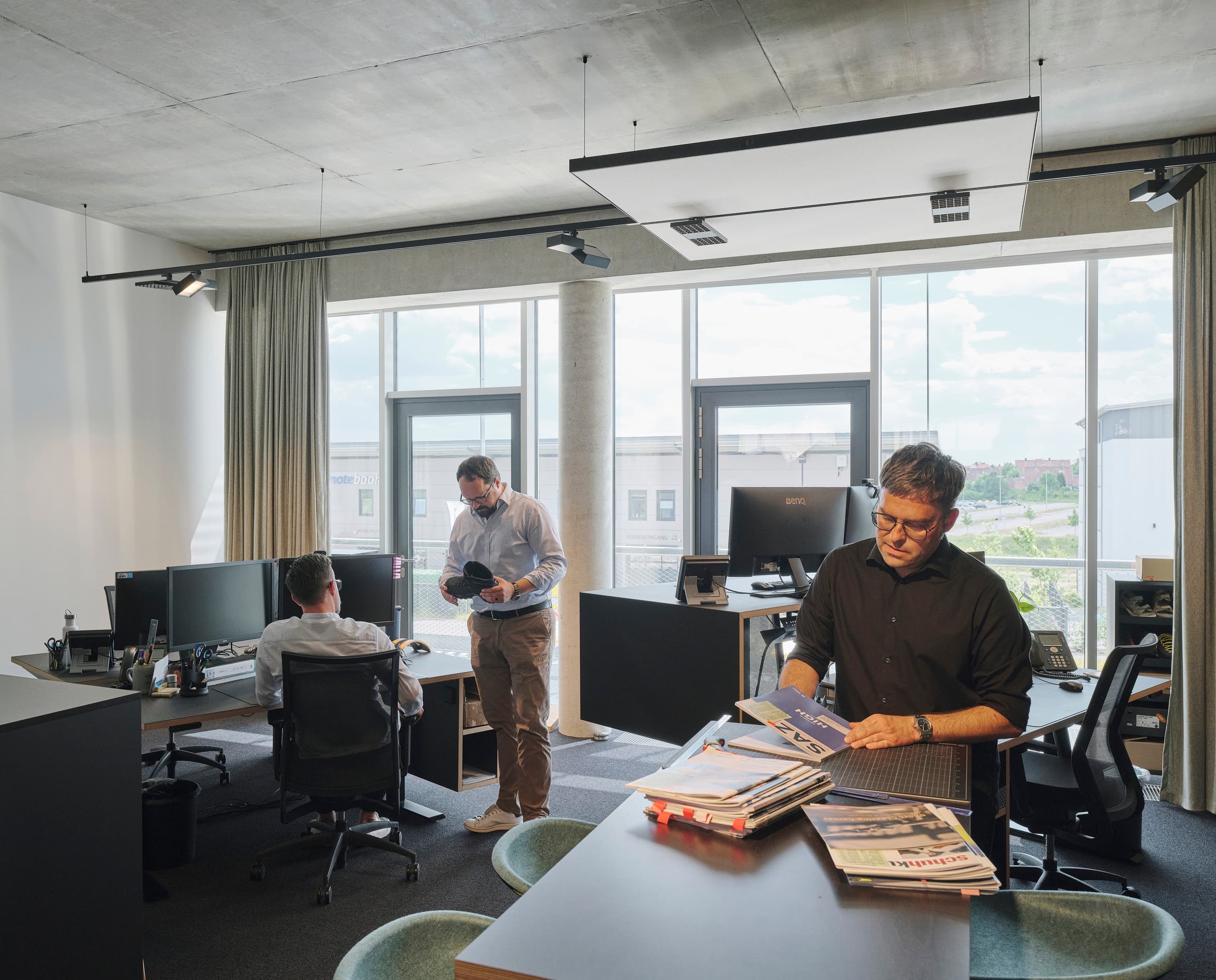 ERCO Bürobeleuchtung im Lowa Büro: Flexible Lichtanpassung für Mitarbeiter und Architektur mit Jilly Downlights und Opton Strahlern.