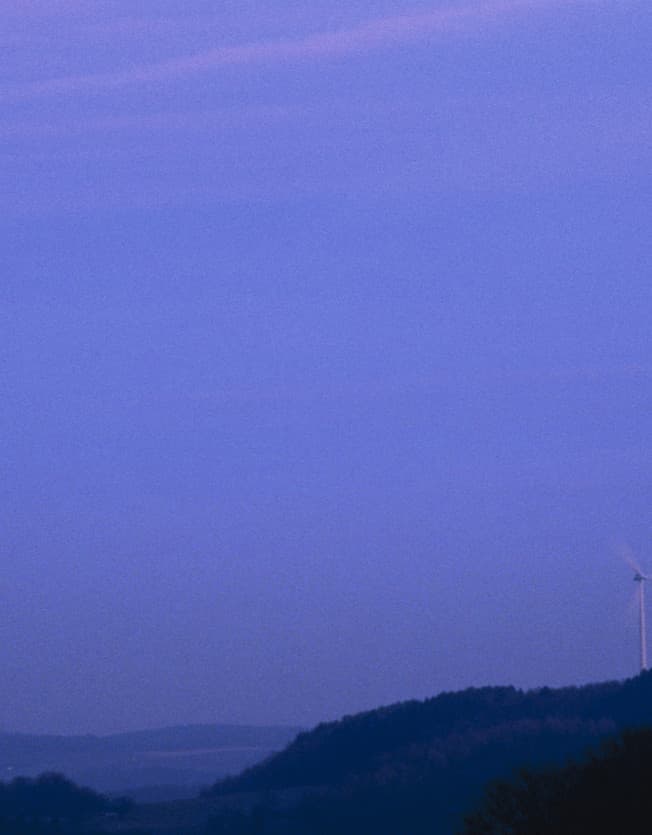 Windrad auf einem Hügel bei Nacht, demonstriert skotopisches Sehen.
