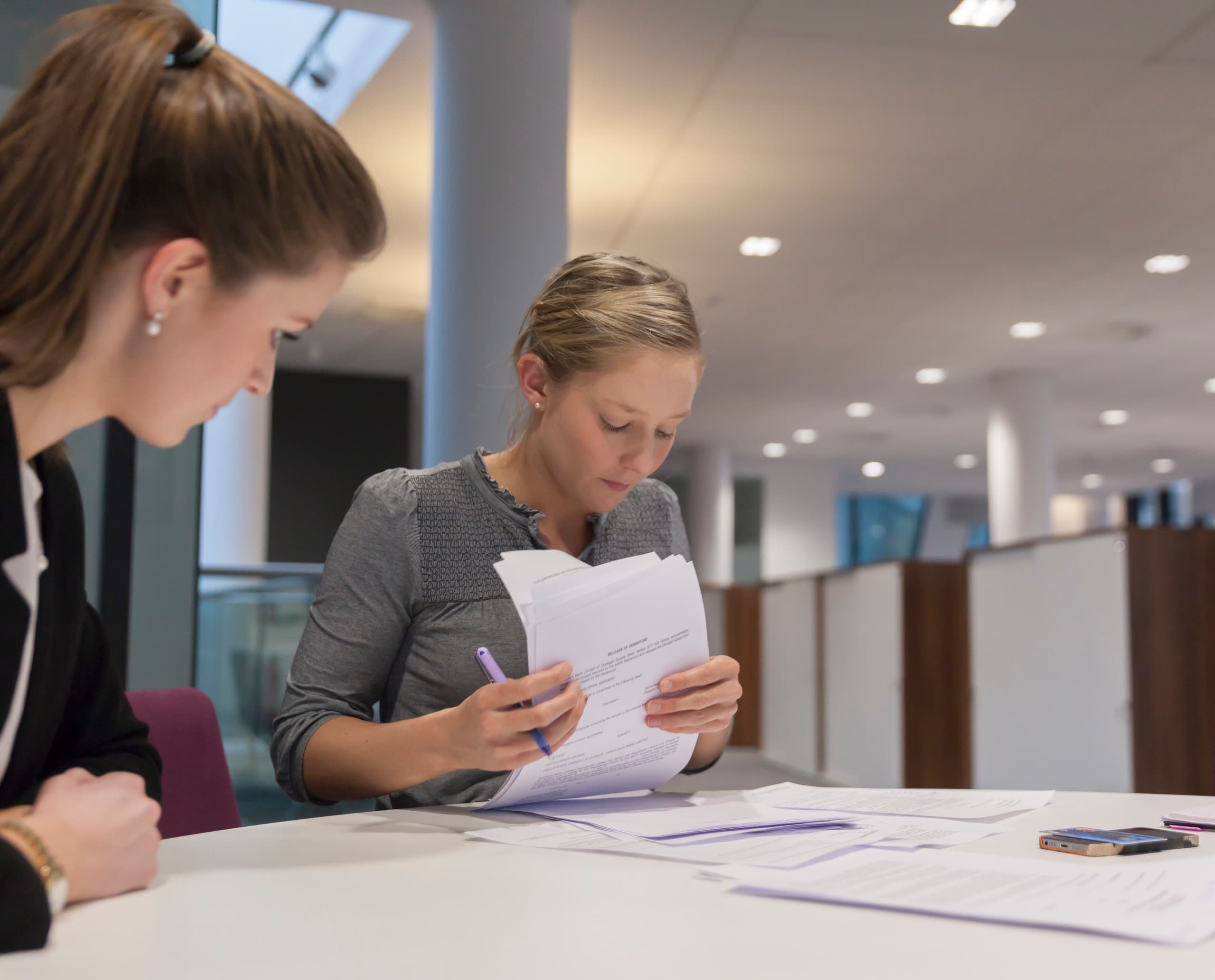 Pinsent Masons Büro: Juristinnen bei der Dokumentenprüfung unter ERCO Bürobeleuchtung.