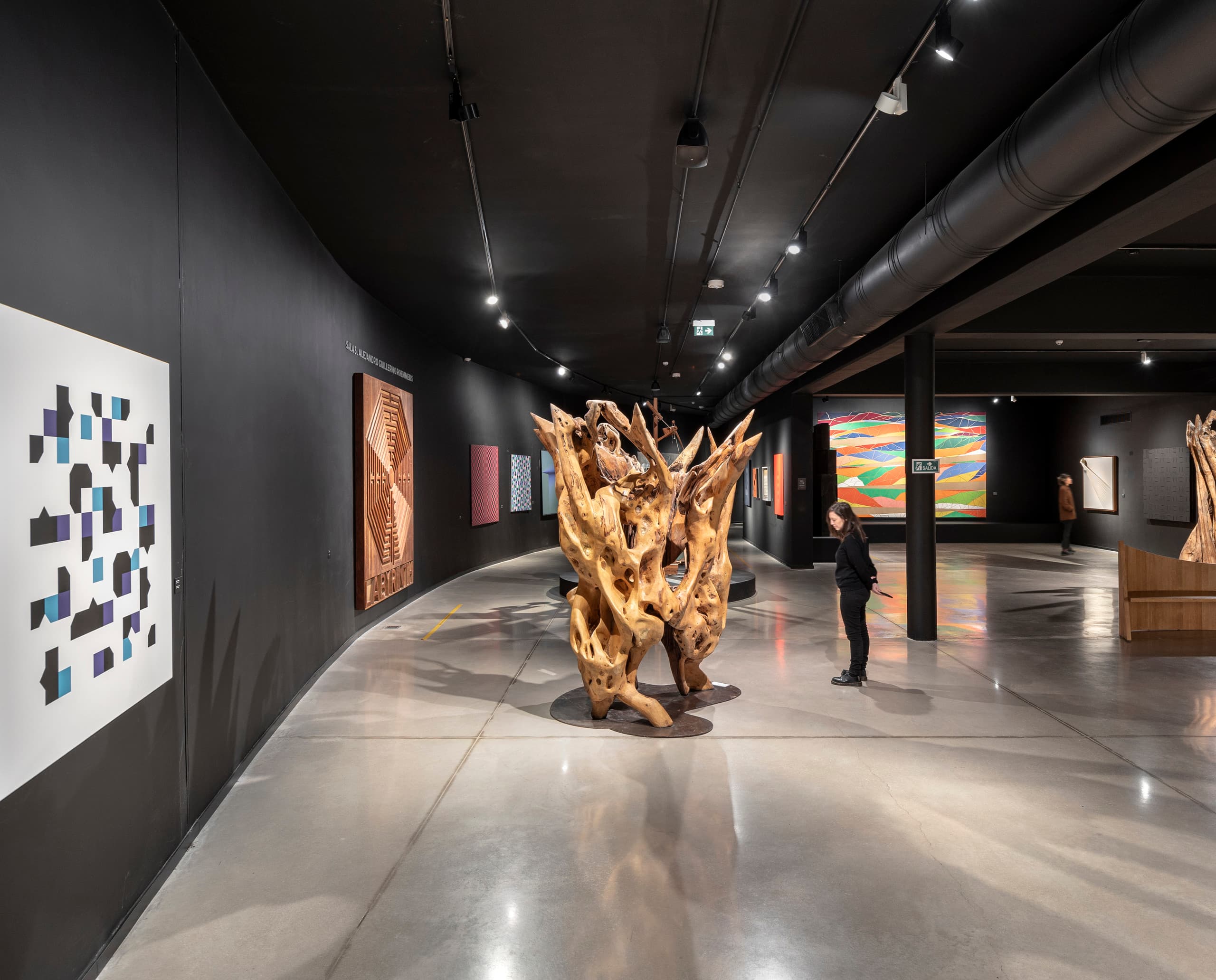 Innenansicht des Museo de Arte Contemporáneo Atchugarry mit ERCO LED-Beleuchtung und Holzskulptur.