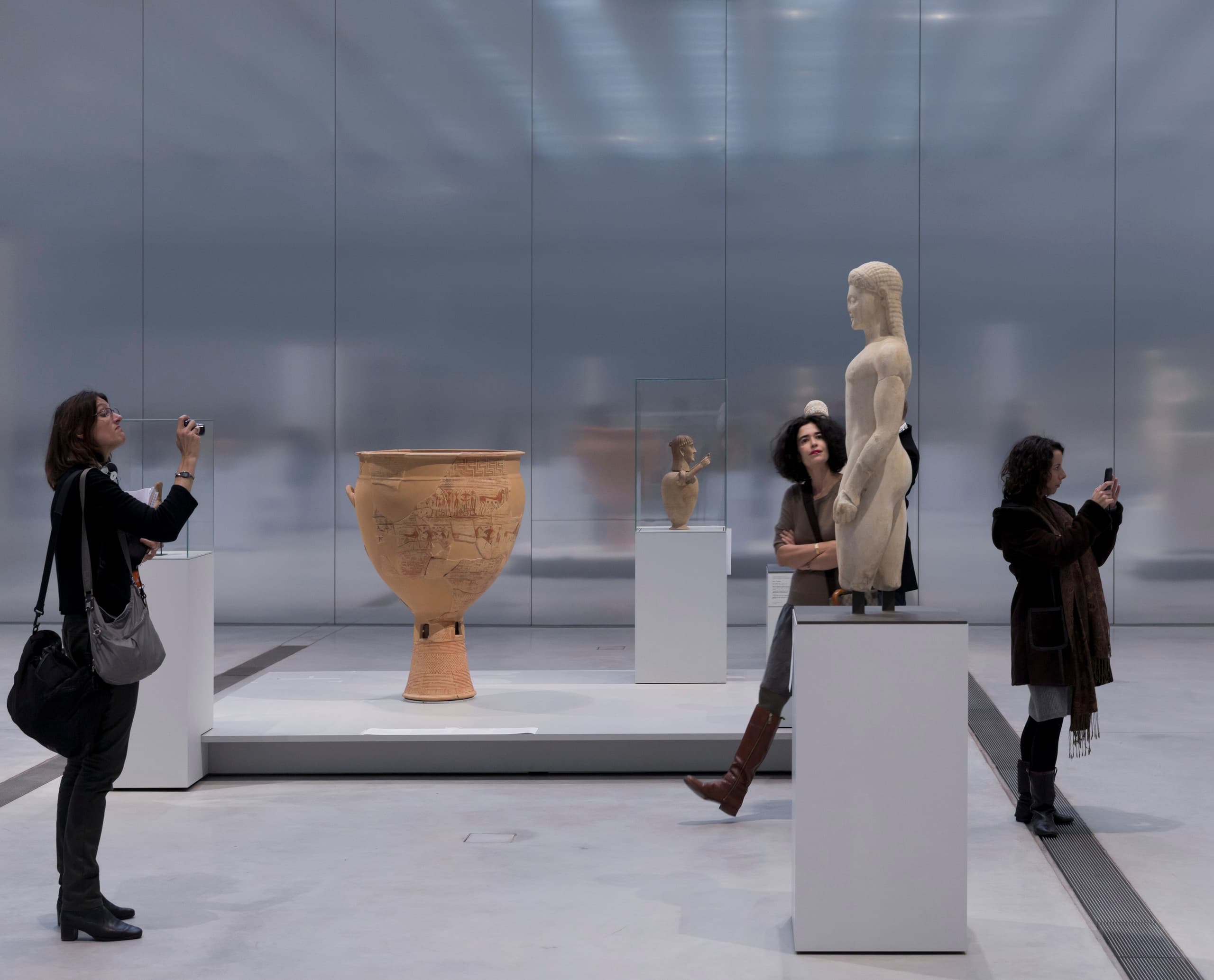 Besucher betrachten antike Kunst im Louvre-Lens, beleuchtet mit ERCO LED-Leuchten.