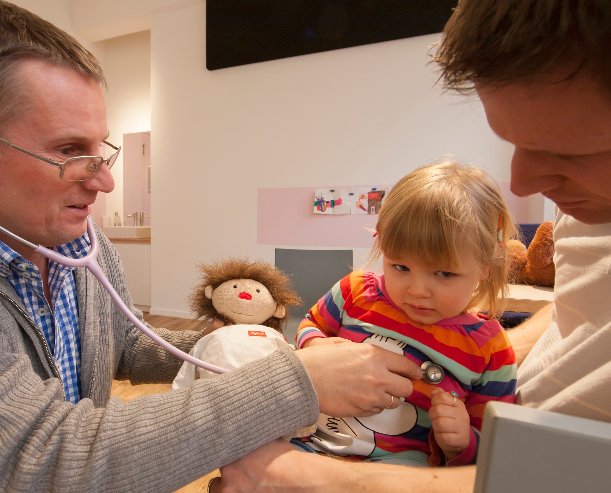 Kinderarzt untersucht ein kleines Mädchen in seiner Praxis in Hamburg.